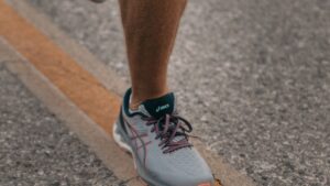 Person running outdoors in athletic shoes
